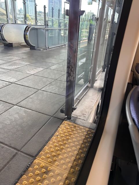 Train interior looking outside showing the train at the very edge of the platform